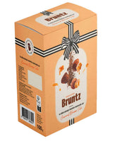 Bruntz Schokoladentrüffel mit Karamell und gesalzener Butter in orangefarbener Geschenkverpackung
