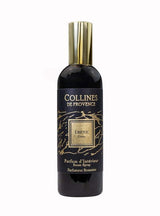 Collines de Provence Raumspray Ebenholz in schwarzer Flasche mit goldfarbenem Verschluss und schwarzem Etikett als Freisteller auf hellem Hintergrund.
