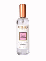 Collines de Provence Raumspray Kirschblüte in transparenter Glasflasche mit weißem Etikett und kupferfarbenem Verschluss auf hellem Hintergrund.